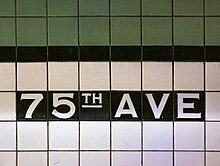 White and green tile mosaic spelling out the station name