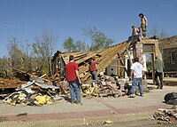 Well-built structures can suffer serious damage, including roof loss, and the collapse of some exterior walls may occur in poorly built structures. Mobile homes, however, are destroyed. Vehicles can be lifted off the ground, and lighter objects can become small missiles, causing damage outside of the tornado's main path. Wooded areas have a large percentage of their trees snapped or uprooted.