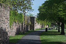 The remains of the abbey's stone precinct walls date from the 13th century