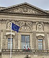 The European Flag is placed on numerous municipal flagpoles in Paris, on a par with the flag of France; here in front of the Louvre Palace (flown upside down)