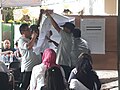 Officials of the KPU and representatives of various organizations and parties witness the vote count at Polling Station 100 in North Jakarta.