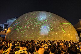 Protesters shining laser lights on the exteriors of the Hong Kong Space Museum, August 2019