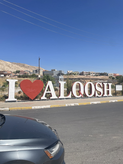 Entry way sign, spelling "I ♡ Alqosh"