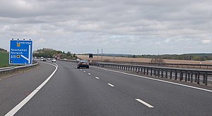 A sign for A11: Newmarket, Norwich to the left, and M11: Cambridge northbound