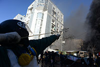 Helmeted combatant fires a slingshot during clashes on February 18, 2014, in Kyiv, Ukraine