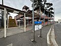 The eastern concourse, footbridge, ramp, stairs and entrance signage, September 2024