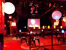 Photograph of a bar's seating area under red light