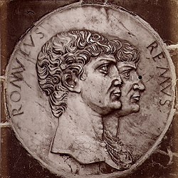 Ceramic medallion featuring the busts of two men facing right, identified as Romulus and Remus.