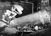 Men disarming an unexploded mortar shell in the Café Adria basement