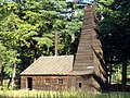 A reconstruction of the Drake Well has two shapes of board-on-board roofing and a horizontal board roof on the tower.