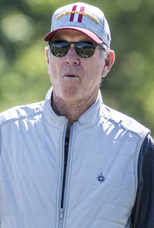 Photograph of Turner standing in a sunny field