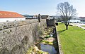 Riverside moat and walls.