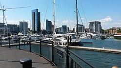 a harbour with tall buildings in the background