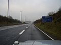 Die A27 bei der Grenze zu Deutschland (fälschlicherweise als deutsche A27 ausgeschildert, siehe Schild rechts)