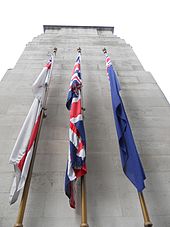 Fabric flags on the side of a stone monument