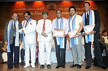 Govinda with five other men onstage