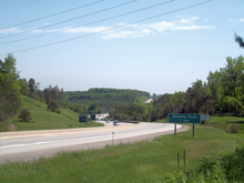 "A photo of a four-lane divided highway on a sunny day."