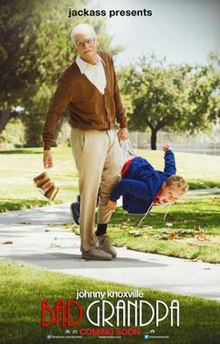 A white-haired old man holds a six-pack of beer in one hand and in the other he carries a boy by the waistband of his pants