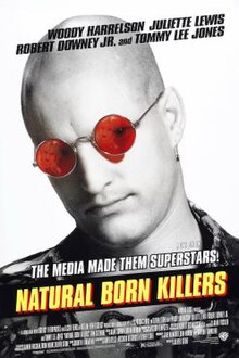 In black-and-white, a bald man sporting a leather jacket wears red sunglasses that contain the reflection of a blonde woman on both lenses, the movie's title is visible.