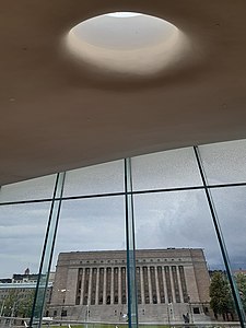 The Parliament House photographed from inside the Oodi Library.