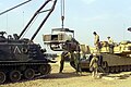 Marines load an M1A1 Abrams tank engine back into the tank at Camp Coyote Feb. 8