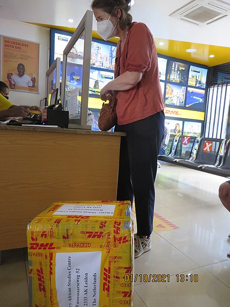 File:ASC Leiden - Rwanda 2021 - 120 - A smiling lady with a face mask at a DHL office - Kigali.jpg