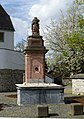 Fountain Friso Brunnen in front of the entry. Coat of arms (1715?).