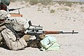 A Marine is shooting with a SVD to familiarize with foreign weapons.