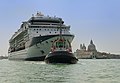 Cruise ship towed by a pilot vessel leaving Venice. Background: Basilica Santa Maria della Salute.