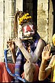 A sadhu playing flute, Benaras.