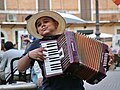 Boy playing accordion in Rome.