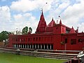 The Durga Temple in Varanasi, built in the 18th century by a Bengali maharani, stained red with ochre overlooking the "Durgakund" pond. It is commonly known as the Monkey Temple due to the many frisky monkeys.