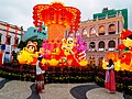 Taking photo in front of Chinese New Year decoration