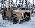 A production standard USMC JLTV in General Purpose (GP) configuration, this example fitted with a deep fording kit and tire chains.