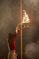 Evening Ganges aarti lamp held aloft, Varanasi.