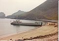 L4041 HMAV Abbeville beached in Village Bay, St Kilda. Supply trailers are lined up on the beach. July 1977.