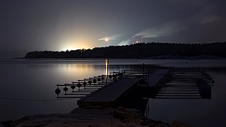 Snowfall at night over Brofjorden and Preemraff oil refinery