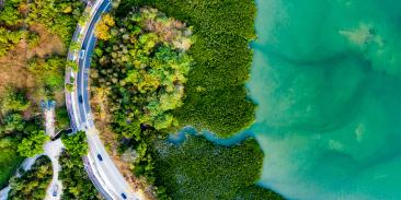 Aerial photo of a road next to a beautiful coastline