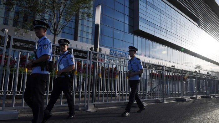 Police officers patrol outside the China National Convention Center in Beijing, May 13, 2017. (