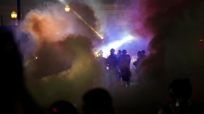 Police in riot gear clear the area in front of Kenosha County Courthouse during clashes with protesters in Kenosha, Wisconsin, August 25, 2020.