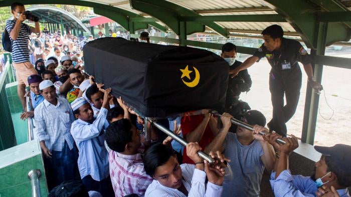 People attend the funeral of Khin Maung Latt