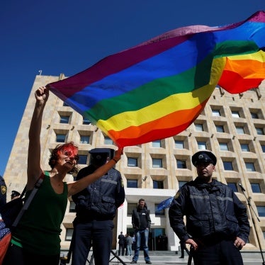 A protester holding an LGBT flag