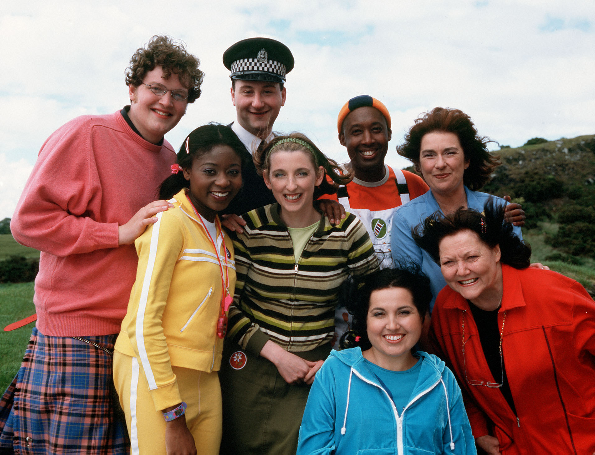 a group of people posing for a picture with one wearing a badge that says ' sdf ' on it