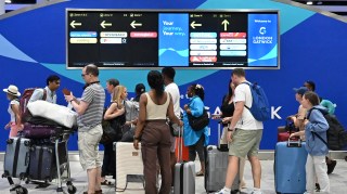 Passengers wait in the check-in area of Gatwick Airport as some flights are cancelled or delayed, in Horley, south of London on July 20, 2024. The British government said Friday that it had activated its civil contingencies committee to handle the response to a global IT outage that hit UK transport and health services. Airports including London Luton, Belfast and Edinburgh warned of longer waiting times for passengers because of the glitch, which was apparently caused by an update to an antivirus programme. (Photo by Justin TALLIS / AFP) (Photo by JUSTIN TALLIS/AFP via Getty Images)