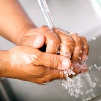 Hand washing. Healthcare worker washing hands in hospital sink under running water. contagious diseases wash hands, handwashing hygiene, virus, human health