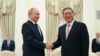 (FILE) Russian President Vladimir Putin, left, and Chinese Premier Li Qiang shake hands during their meeting at the Kremlin in Moscow, Russia, Aug. 21, 2024. 