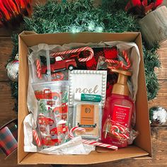 a christmas gift box with personal care items and candy canes on the table next to it