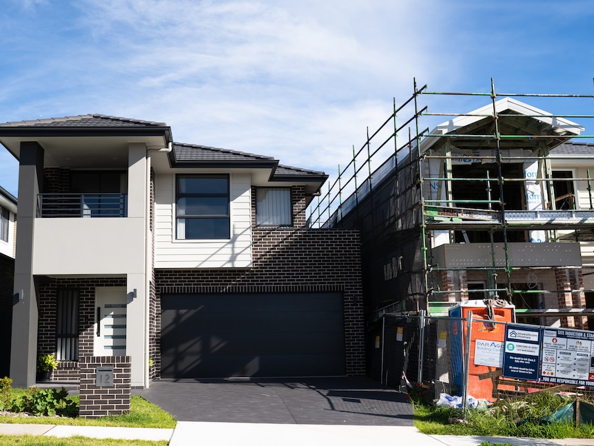 Houses under construction on a bright, sunny day