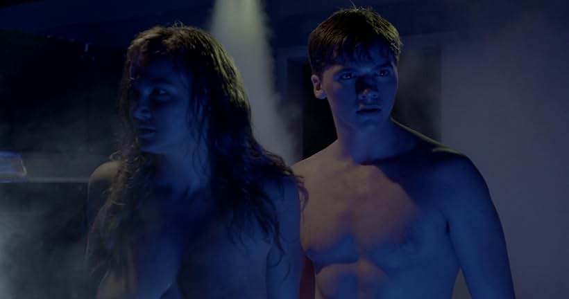 Joel Courtney and Andi Matichak in Assimilate (2019)