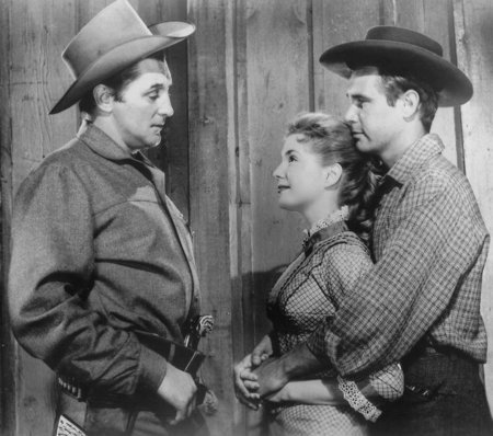 Karen Sharpe stars as Stella Atkins, Robert Mitchum as Clint Tollinger, and John Lupton as Jeff Castle in Man with the Gun